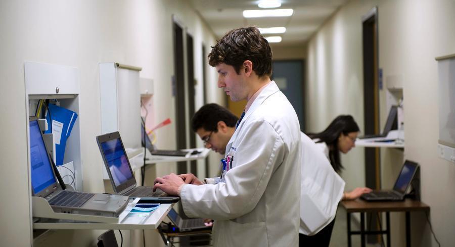 Doctors using computers are pictured.