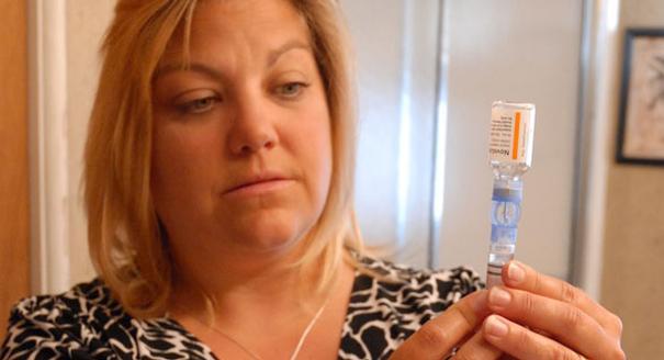 Valerie Nash prepares her insulin pump. She was repeatedly turned down for insurance because of her pre-existing condition.