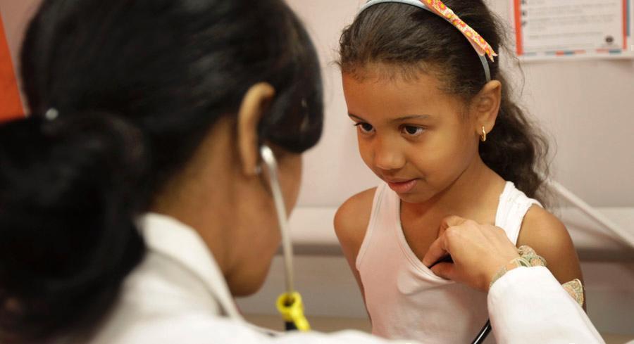 A doctor and her young patient are pictured.